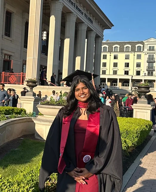 Sreesha in her graduation gown outside the Indiana Memorial Union