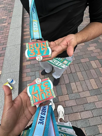 Two Run 317 finisher medals held up side by side